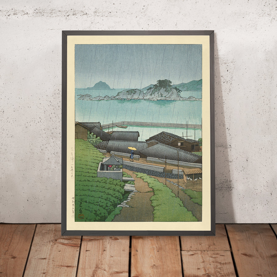 A framed image of Rainy Coastal Japanese Village by Hasui Kawase 1935